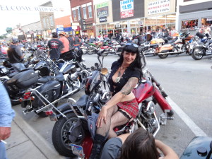 Beautiful Lady on a motorcycle in downtown Sturgis at the 2013 Sturgis Motorcycle Rally