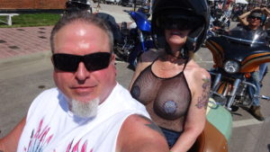 California Motorcycle Accident and Biker Lawyer Norman Gregory Fernandez with wife little Teri on their motorcycle main drag, Sturgis 2019